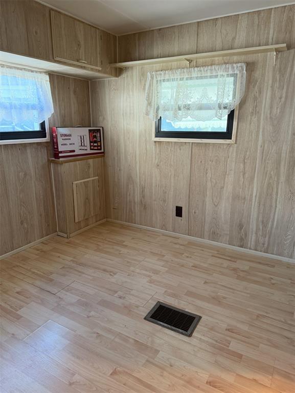 9486 Gray Fox Drive Weeki Wachee, FL 34613 - Photo 19 of 43 a view of a room with wooden floor