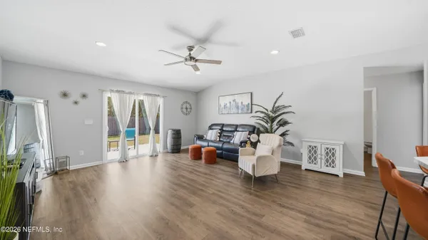 a living room with furniture and wooden floor