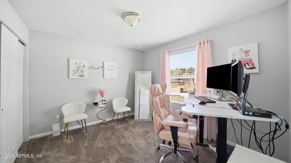 a view of a livingroom with furniture and a window