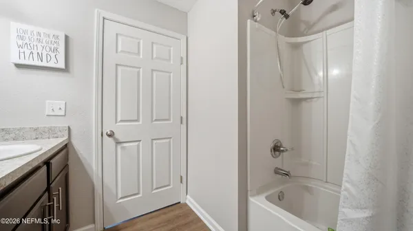 a view of a room with a ceiling fan