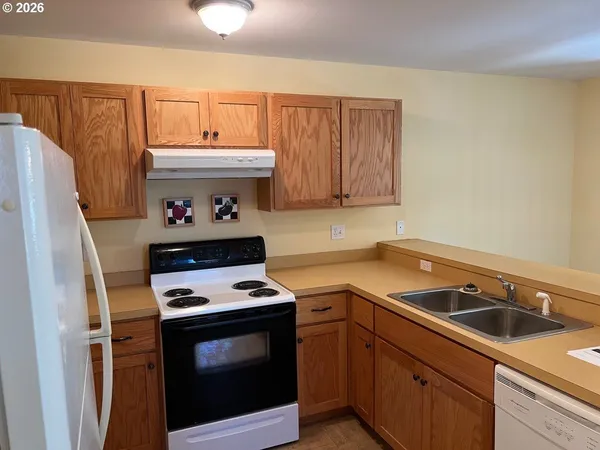a kitchen with a stove and a refrigerator