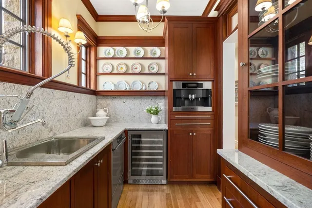 a kitchen with stainless steel appliances granite countertop a sink and wooden cabinets