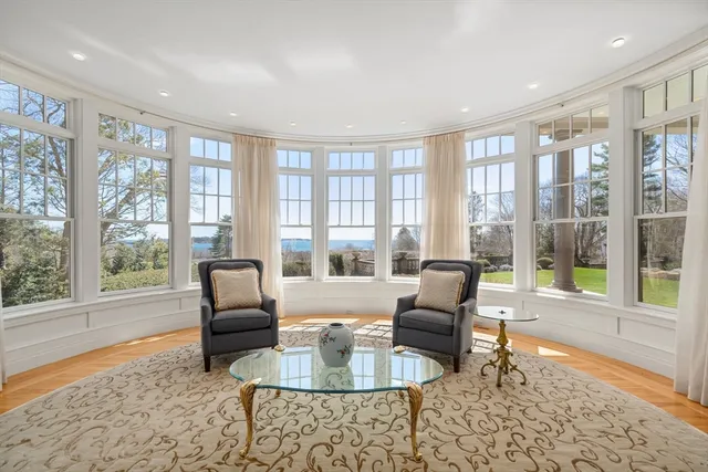 a living room with furniture and large windows