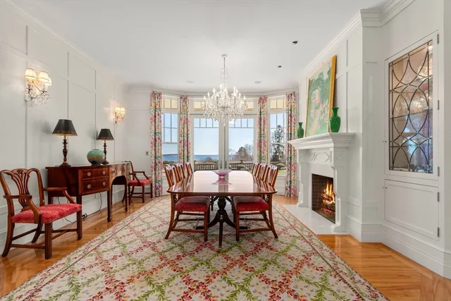 a living room with furniture a chandelier and a fireplace