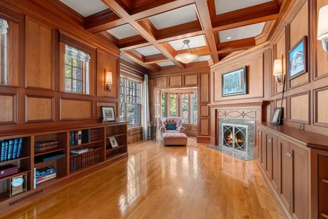a living room with furniture fireplace and wooden floor
