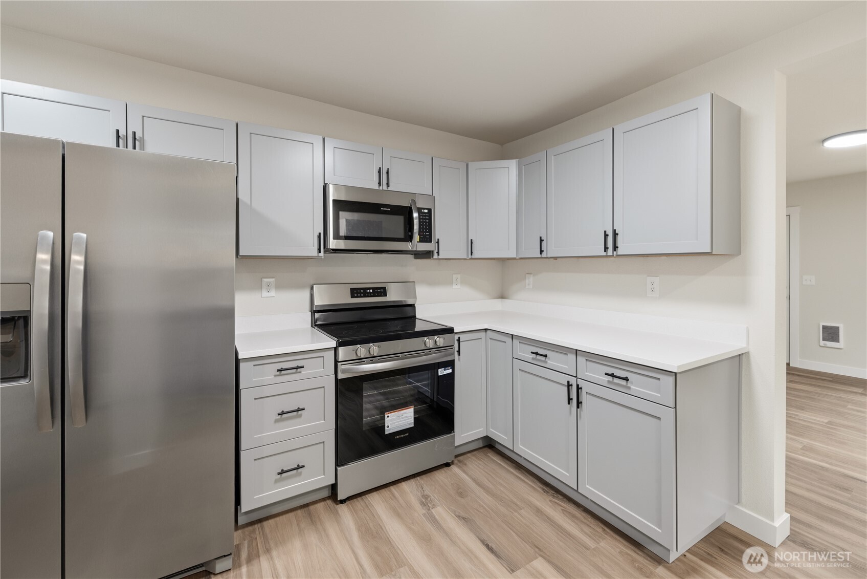 288 21st Avenue Longview, WA 98632 - Photo 5 of 22 a kitchen with white cabinets and stainless steel appliances