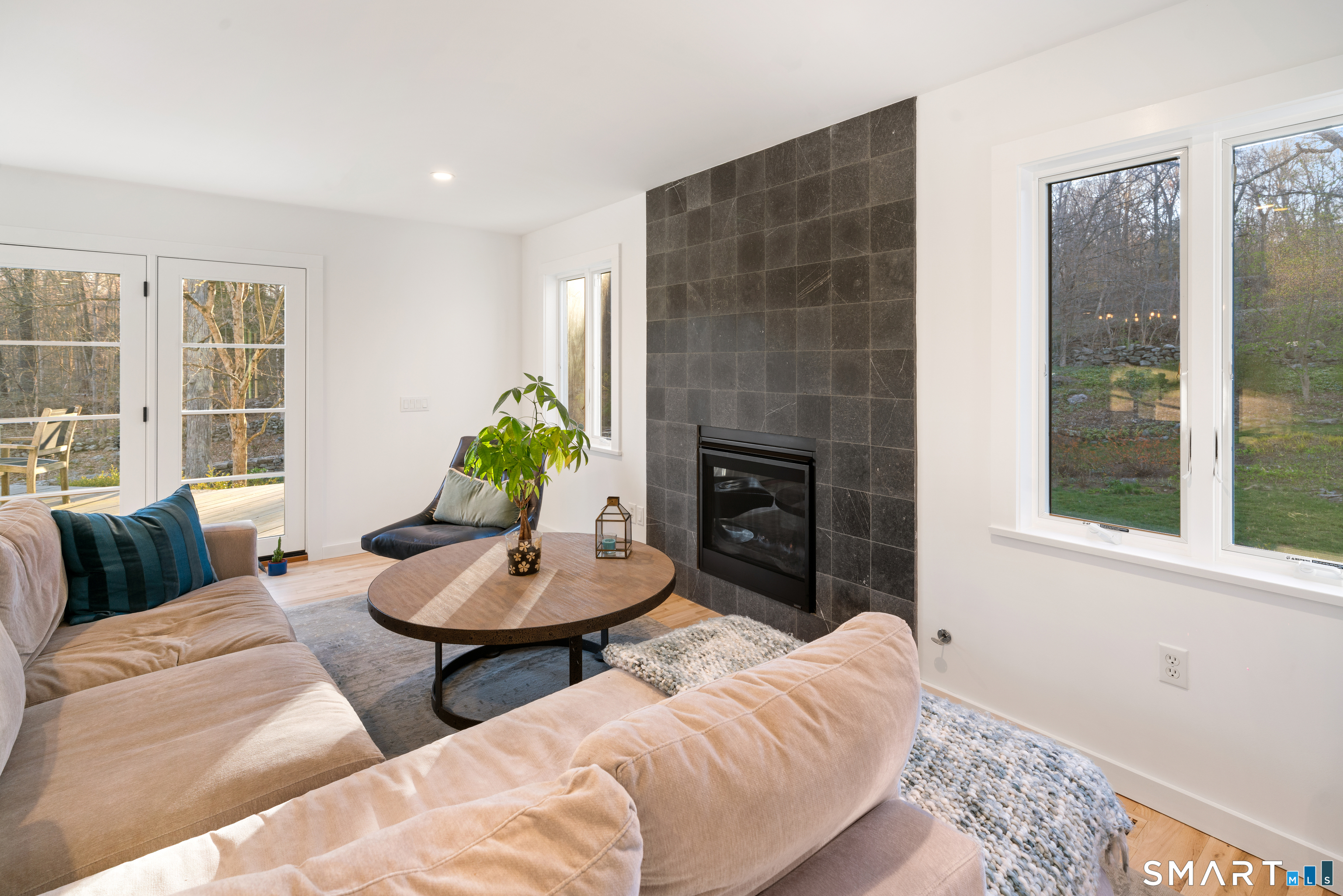 23 Norton Road Easton, CT 06612 - Photo 12 of 40 Enjoy a fire surrounded by oversized windows and beautiful glass doors that bring nature into the space.