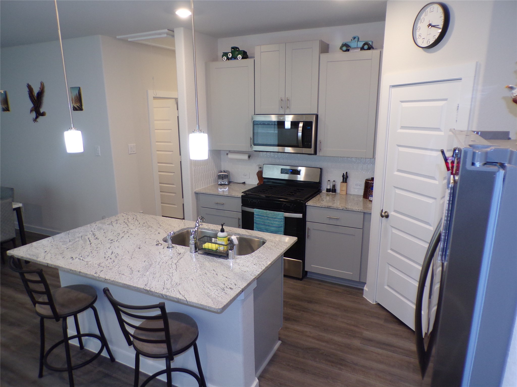 15419 Dapple Blf Lane Conroe, TX 77302 - Photo 2 of 19 a kitchen with a table chairs and refrigerator