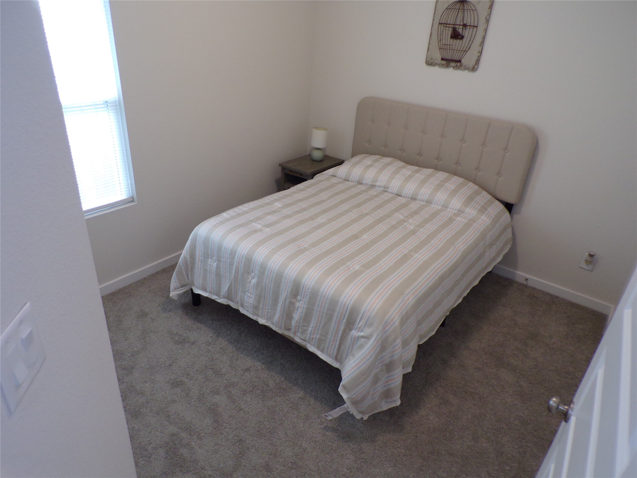 15419 Dapple Blf Lane Conroe, TX 77302 - Photo 6 of 19 a bed sitting in a bedroom next to a window