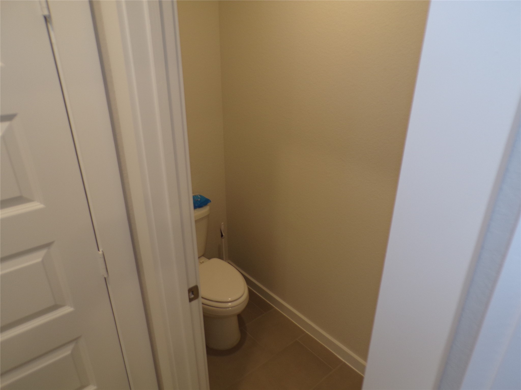 15419 Dapple Blf Lane Conroe, TX 77302 - Photo 10 of 19 a white toilet sitting next to a wooden wall