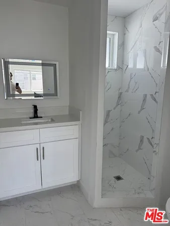 a bathroom with a shower and vanity
