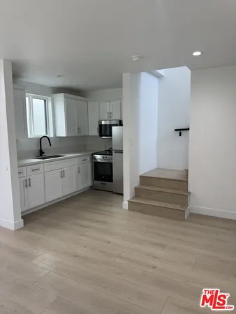 a kitchen with stainless steel appliances granite countertop a sink and cabinets