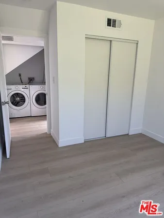 a view of an empty room with a washer and dryer