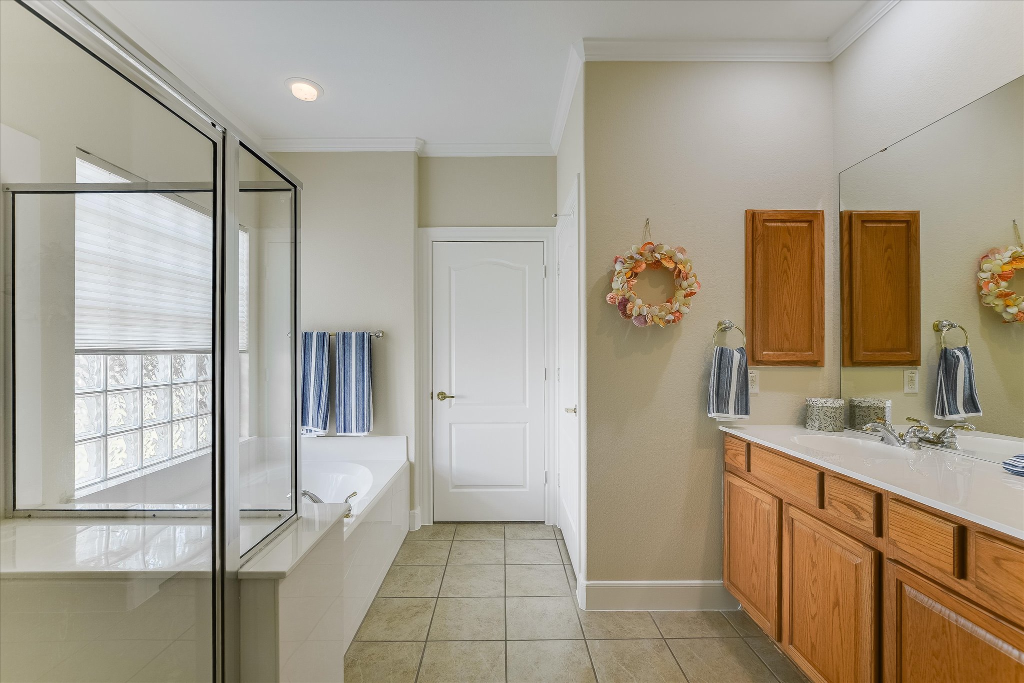 603 Rio Grande Loop Georgetown, TX 78633 - Photo 15 of 27 Full bathroom featuring vanity, a shower stall, crown molding, a bath, and light tile patterned floors