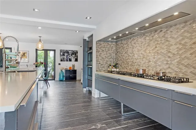 a view of a kitchen with white cabinets