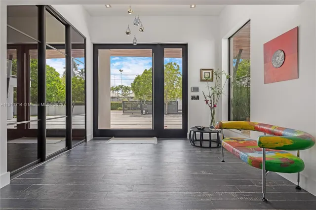 a bedroom with a large bed and a flat tv screen on dresser