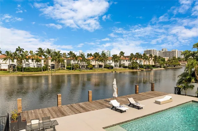 a living room with furniture and large windows