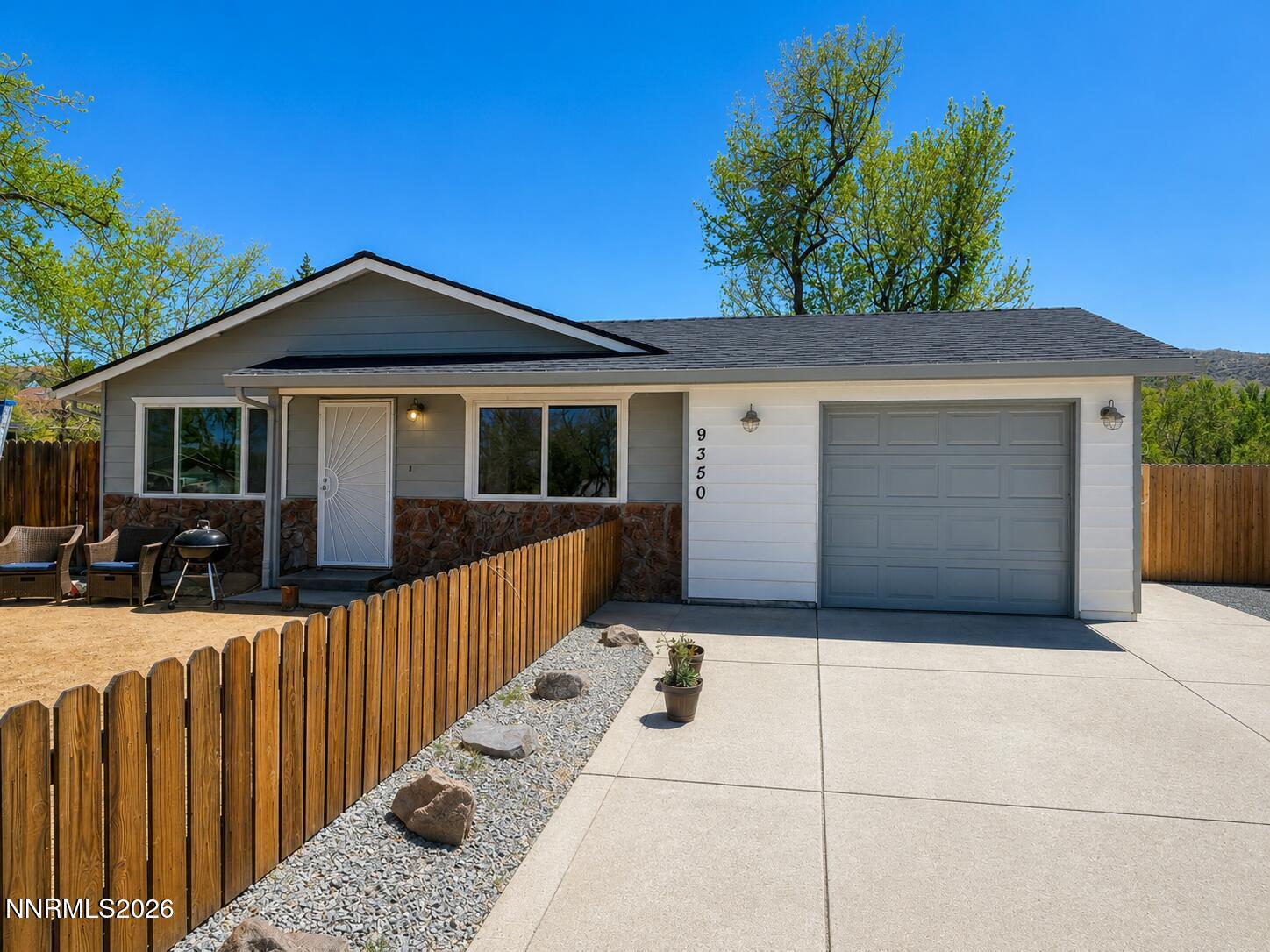 9350 Gremlin Way Reno, NV 89506 - Photo 1 of 7 a front view of a house with a yard