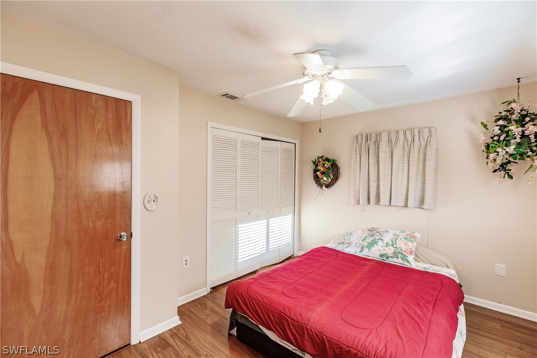 18506 Geranium Road Fort Myers, FL 33967 - Photo 16 of 32 a bedroom with a bed and a window