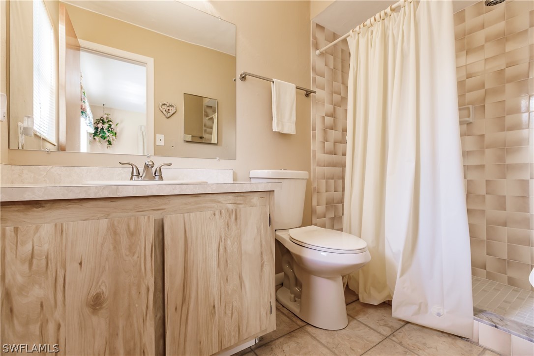 18506 Geranium Road Fort Myers, FL 33967 - Photo 17 of 32 a bathroom with a sink toilet and shower