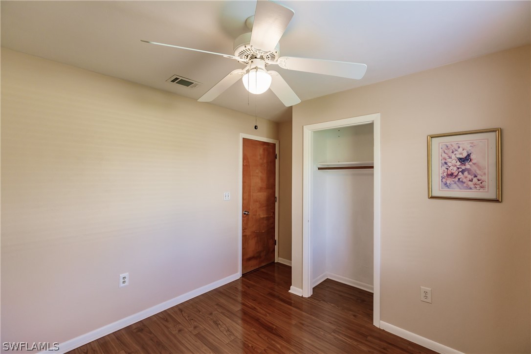 18506 Geranium Road Fort Myers, FL 33967 - Photo 19 of 32 a view of an empty room with wooden floor