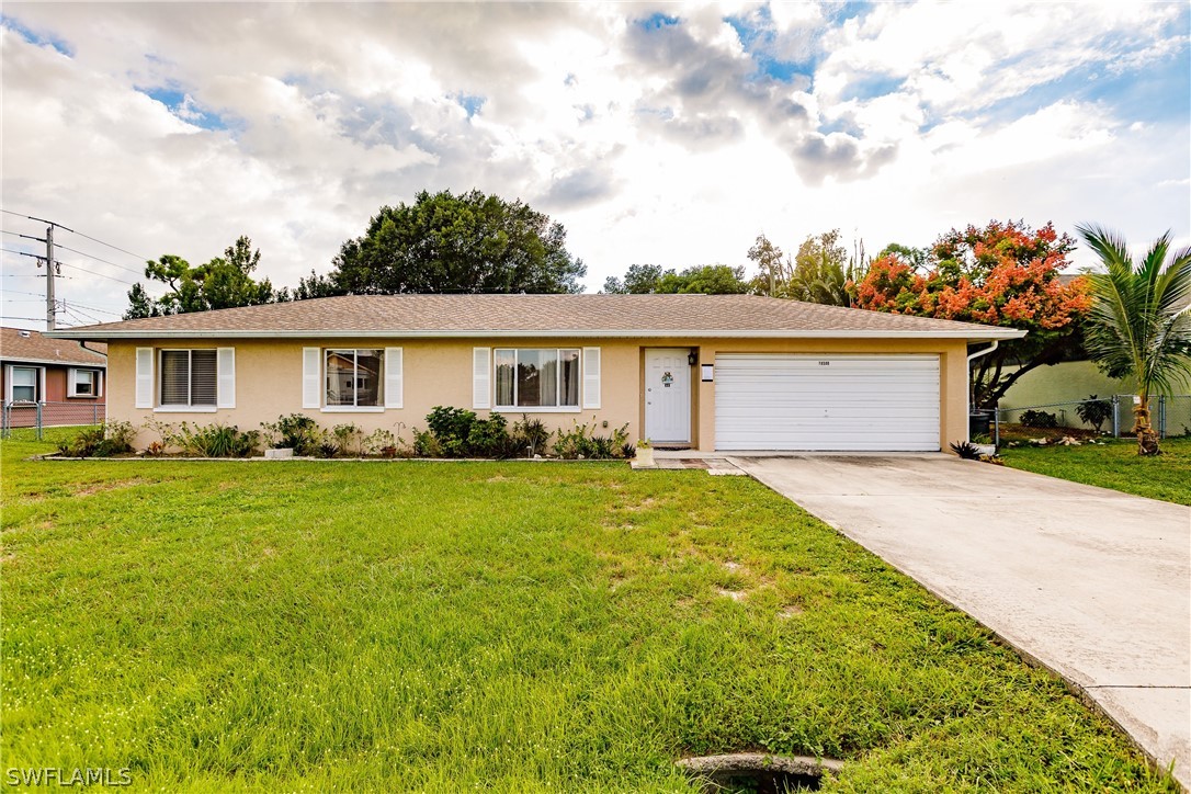 18506 Geranium Road Fort Myers, FL 33967 - Photo 2 of 32 a front view of house with yard and trees