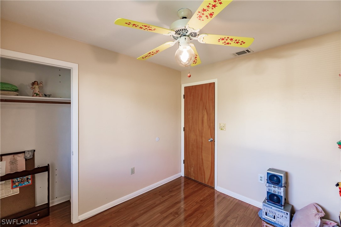 18506 Geranium Road Fort Myers, FL 33967 - Photo 21 of 32 a view of an empty room with wooden floor