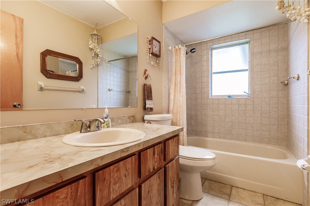 18506 Geranium Road Fort Myers, FL 33967 - Photo 22 of 32 a bathroom with a granite countertop sink toilet mirror and shower