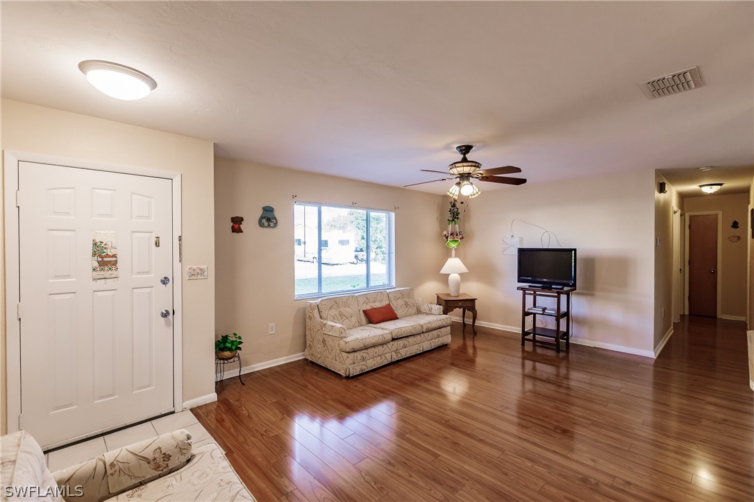 18506 Geranium Road Fort Myers, FL 33967 - Photo 4 of 32 a living room with furniture and wooden floor