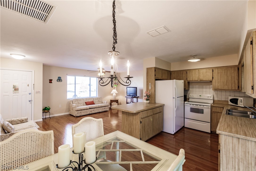 18506 Geranium Road Fort Myers, FL 33967 - Photo 6 of 32 a kitchen with refrigerator and cabinets