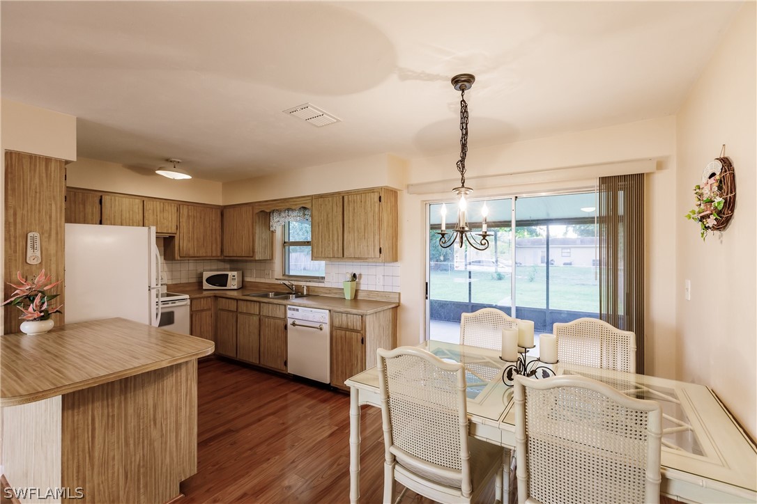 18506 Geranium Road Fort Myers, FL 33967 - Photo 10 of 32 a open dining room with stainless steel appliances granite countertop furniture and a kitchen view