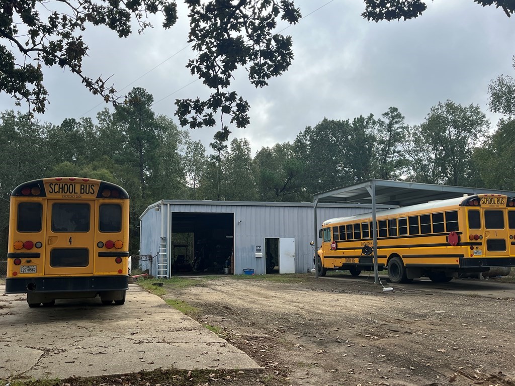 215 Buchanan Street Broaddus, TX 75929 - Photo 26 of 30 a front view of a house with a yard and car parked