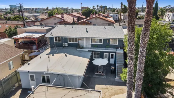 an aerial view of a house with wooden floor and city view