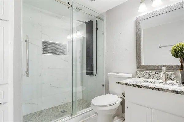 a bathroom with a sink toilet and shower