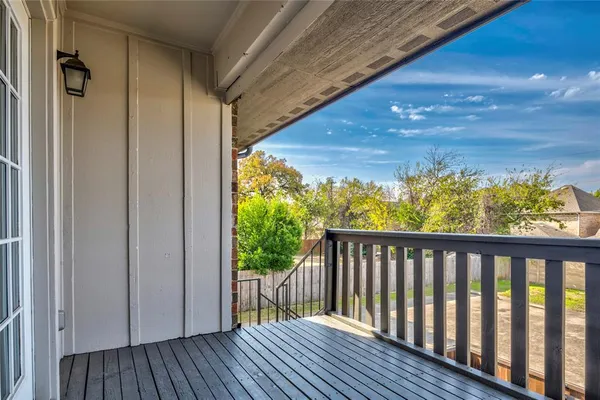 a view of a balcony with wooden floor