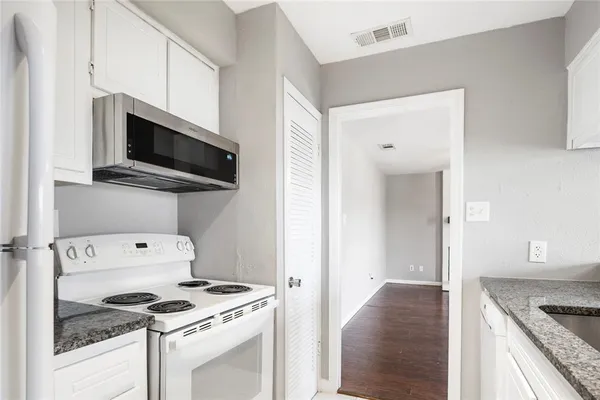 a kitchen with a stove and a microwave