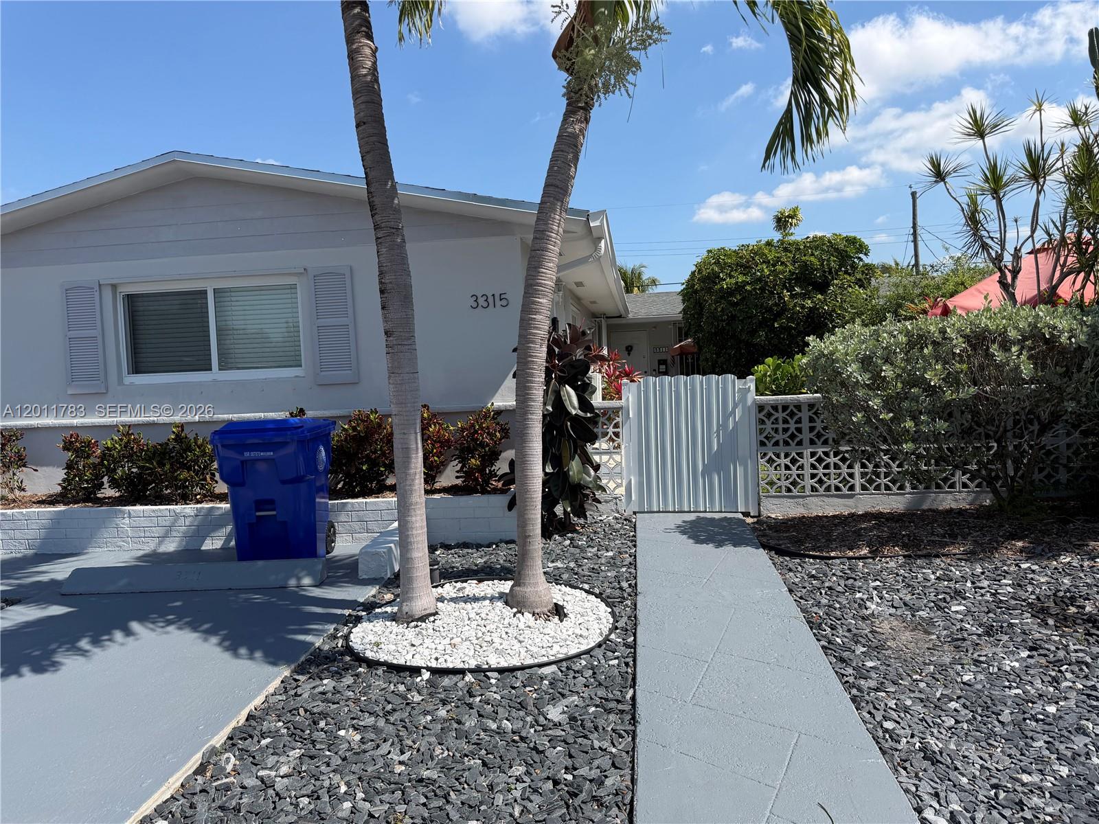 3311 Southwest 25th Terrace, Unit 3315 Miami, FL 33133 - Photo 3 of 10 a backyard of a house with a table and chairs