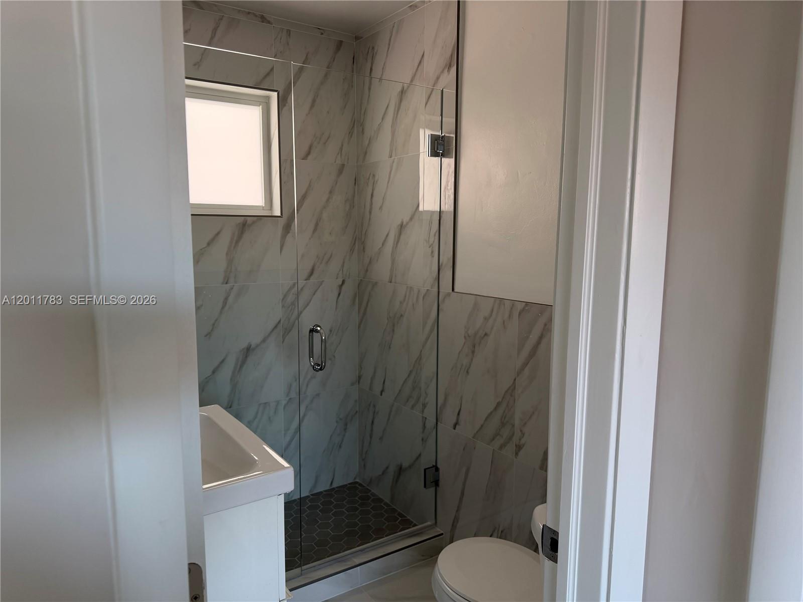 3311 Southwest 25th Terrace, Unit 3315 Miami, FL 33133 - Photo 5 of 10 a bathroom with a toilet and a shower