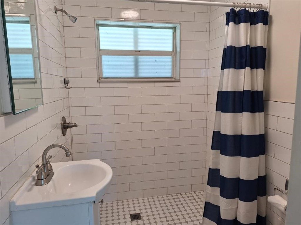 9150 44th Avenue, Unit 15 Sebastian, FL 32958 - Photo 13 of 21 a bathroom with a sink toilet and shower