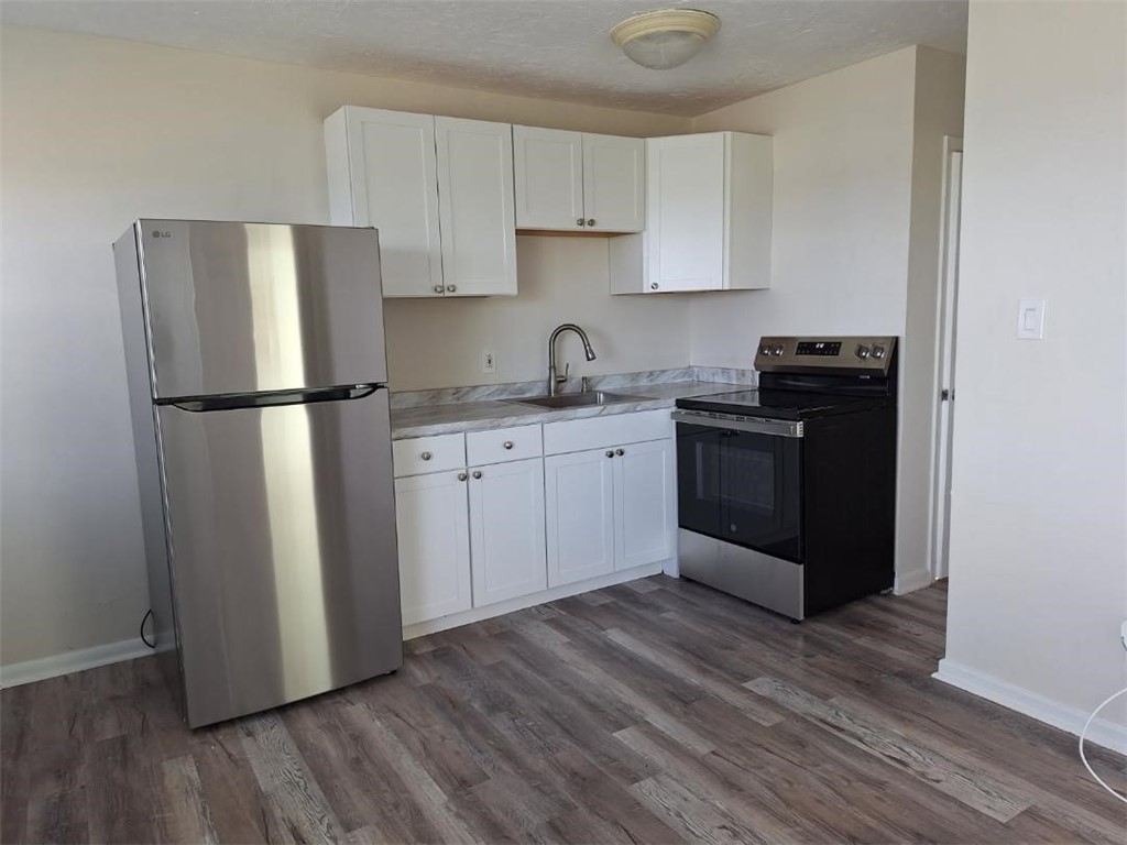 9150 44th Avenue, Unit 15 Sebastian, FL 32958 - Photo 14 of 21 a kitchen with a refrigerator sink and cabinets