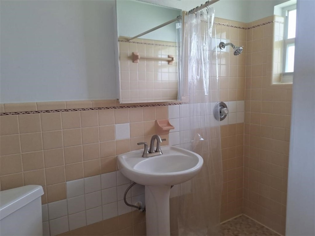 9150 44th Avenue, Unit 15 Sebastian, FL 32958 - Photo 15 of 21 a bathroom with a sink a toilet and shower