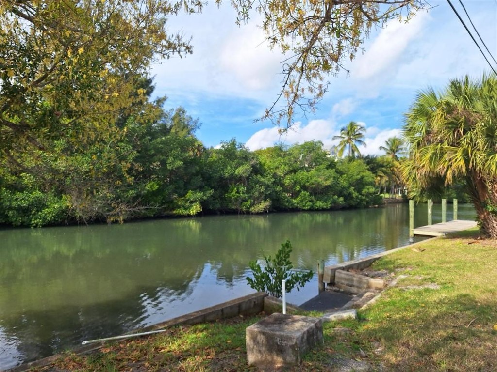 9150 44th Avenue, Unit 15 Sebastian, FL 32958 - Photo 8 of 21 a view of a lake with a house in the background