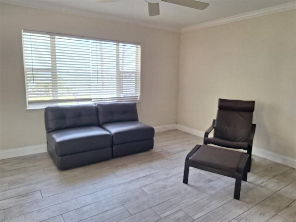 9150 44th Avenue, Unit 15 Sebastian, FL 32958 - Photo 9 of 21 a living room with furniture and a window