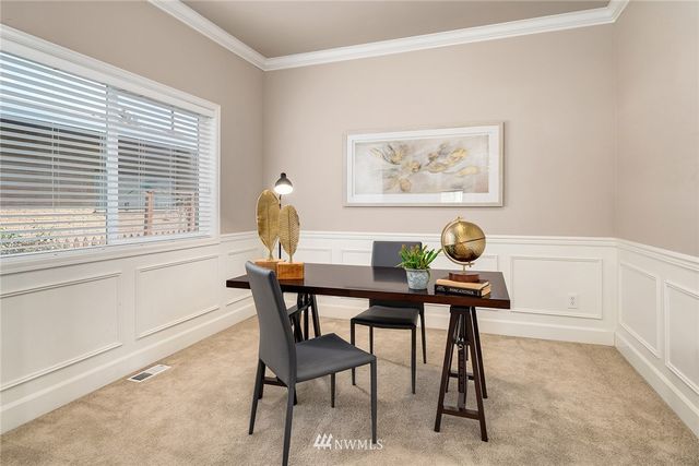 a view of a dining room with furniture and window
