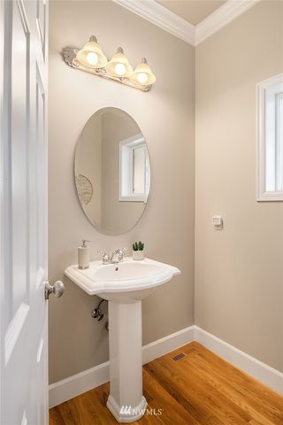 a bathroom with a sink mirror and vanity