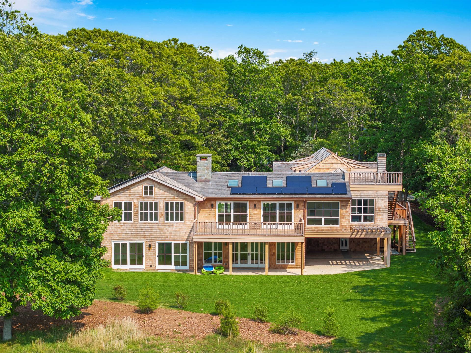 206 Water Hole Road East Hampton, NY 11937 - Photo 2 of 32 a front view of a house with a garden