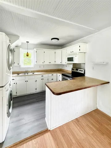 a kitchen with granite countertop a sink and cabinets