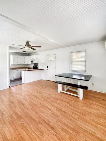 a living room with stainless steel appliances kitchen island a stove a refrigerator cabinets and living room view
