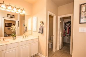 1409 Rosson Road Little Elm, TX 75068 - Photo 17 of 34 Dual vanity with white cabinetry, integrated sinks, and polished chrome faucets