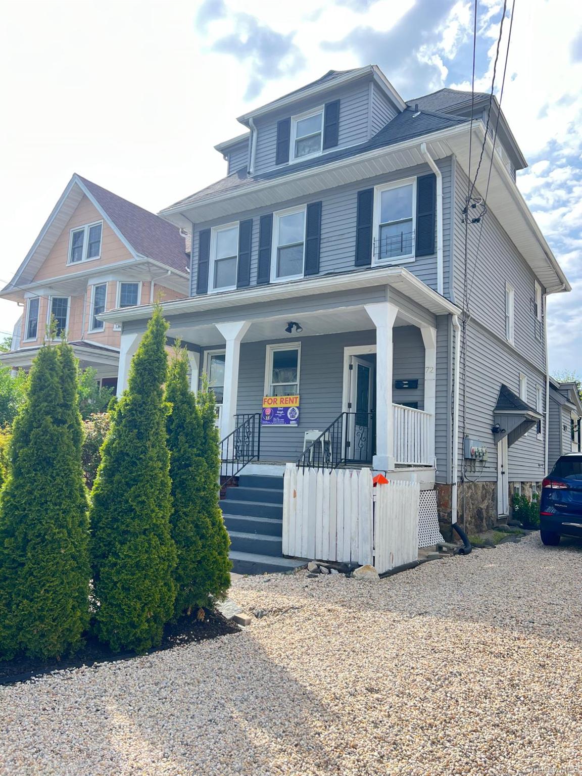 72 Chauncey Avenue New Rochelle, NY 10801 - Photo 1 of 14 a view of a white house with large windows next to a road